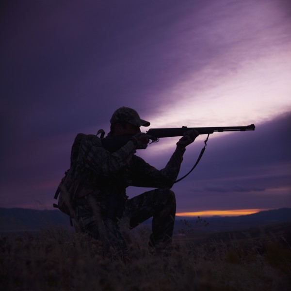 Hunter pointing his rifle. Photo : Mike Kemp