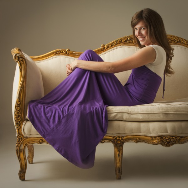Elegant woman sitting on antique sofa. Photo : Mike Kemp