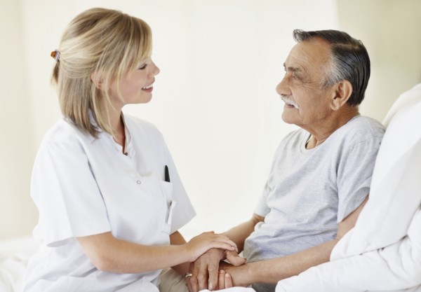 Nurse sitting with patient. Photo. momentimages