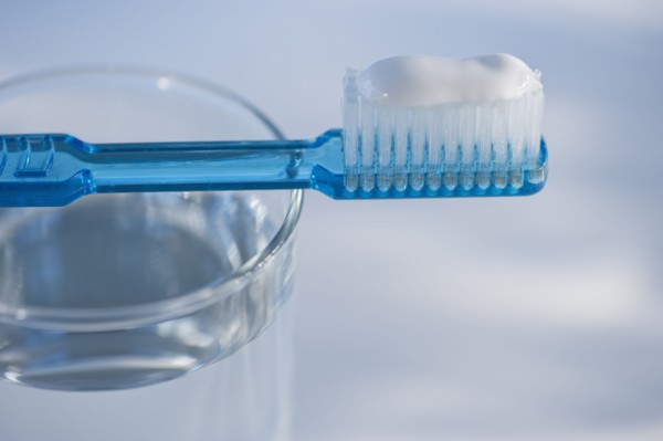 Toothbrush and glass of water. Photo. Daniel Grill