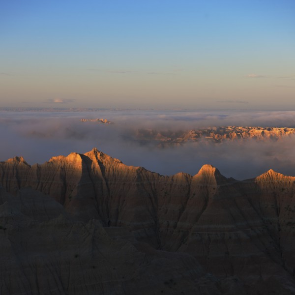 USA, South Dakota, Mountains in morning fog in Badlands National Park.