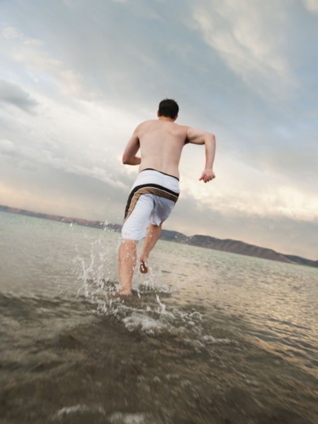 Man running on beach.