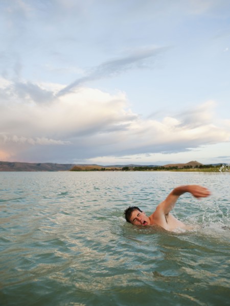 Man swimming in lake.