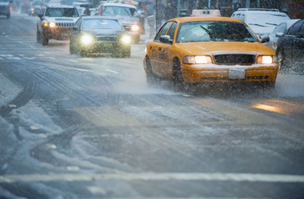 USA, New York, New York City, Traffic on street in snow.