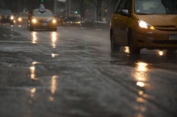 USA, New York, New York City, Traffic on street in snow, dusk.