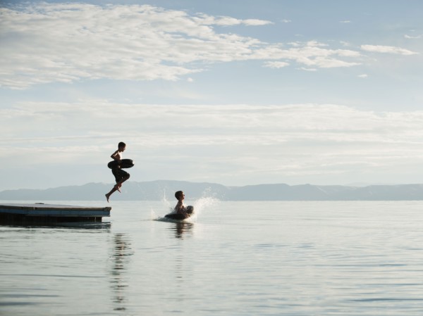 Boys (10-11,12-13) jumping from raft.