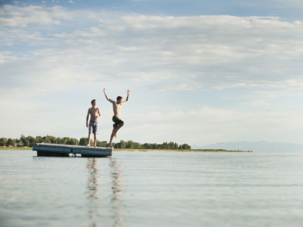 Boys (10-11,12-13) jumping from raft.