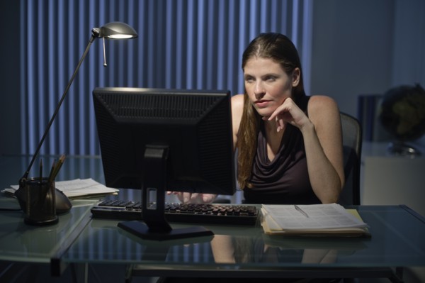 Woman working late in office.