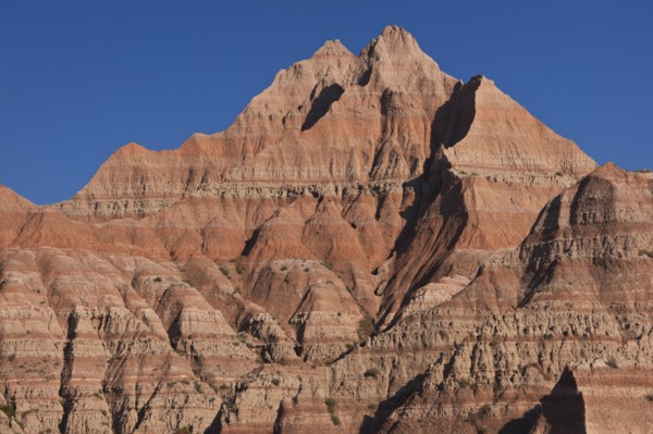 USA, South Dakota, Mountain against blue sky in Badlands National Park.