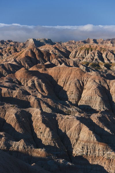 USA, South Dakota, Mountains in morning fog in Badlands National Park.