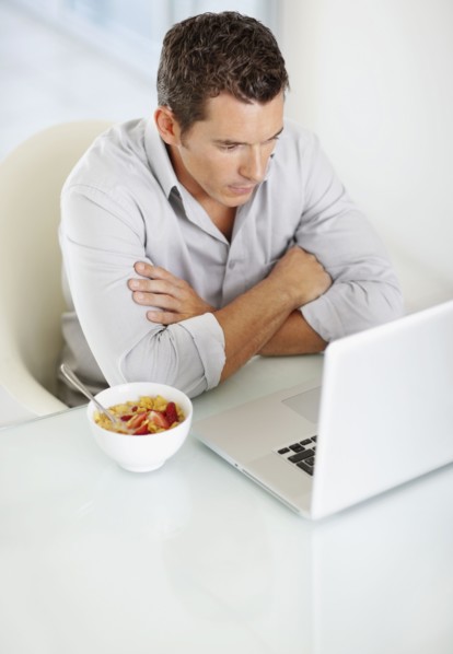 Portrait of enthusiastic man working on laptop. Photo : Momentimages