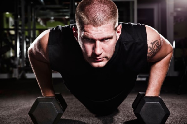 Mid adult man working out in gym. Photo : Take A Pix Media