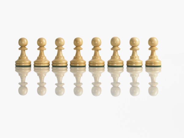 Row of pawn chess pieces. Photo : David Arky