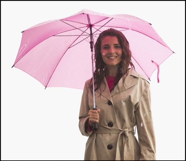 Studio portrait of young woman with umbrella. Photo : Mike Kemp