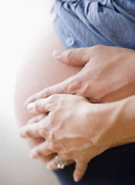 Young man hugging pregnant woman. Photo : Jamie Grill