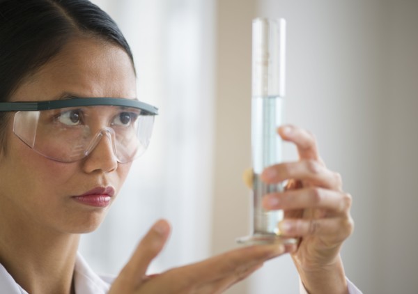 USA, New Jersey, Jersey City, Female scientist holding chemical test tube.