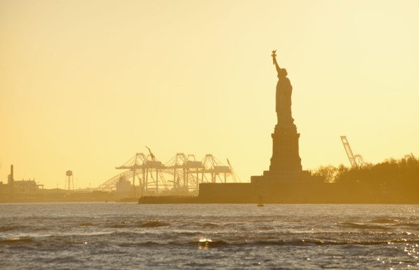 USA, New York City, Staten Island, Harbor and silhouette of Statue of Liberty in background.