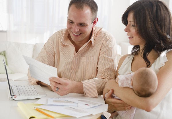 USA, New Jersey, Jersey City, Family with baby daughter (2-5 months) reading correspondence. Photo