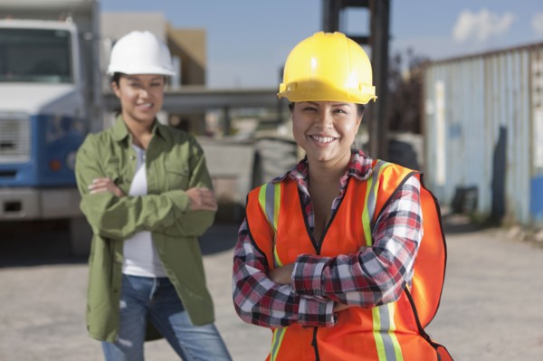 Portrait of two female construction workers on building site. Photo : Dan Bannister