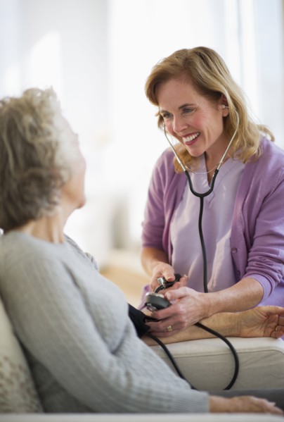 USA, New Jersey, Jersey City, Female nurse checking patients blood pressure.