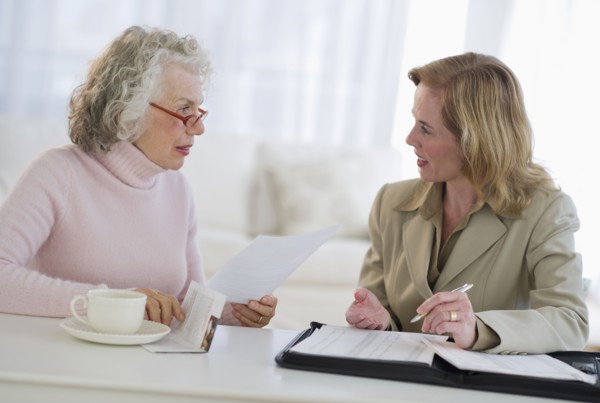 USA, New Jersey, Jersey City, Senior woman talking to financial advisor in home.