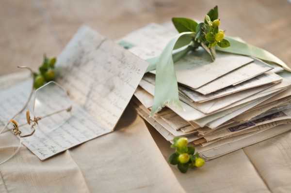 Flowers on pile of letters.