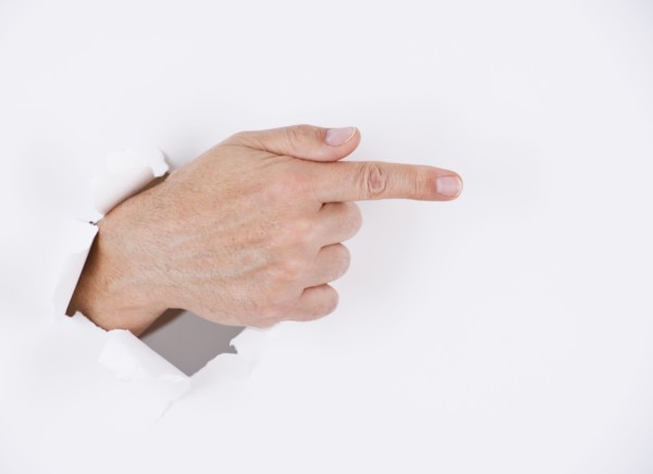 Hand on white background pointing. Photo : Daniel Grill
