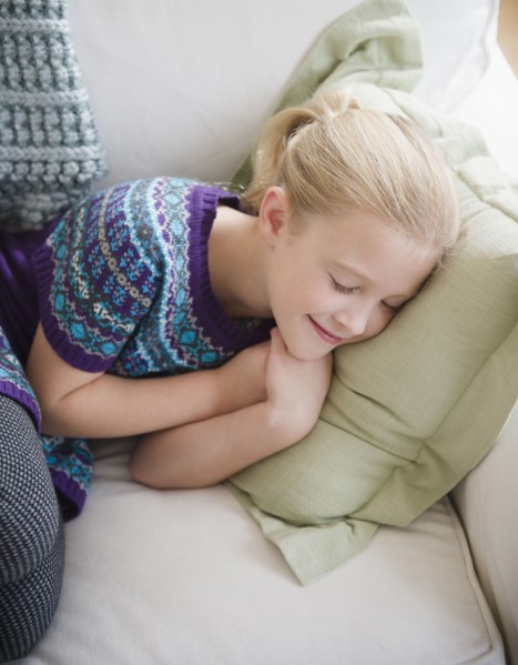 USA, New Jersey, Jersey City, Girl (8-9) sleeping on sofa. Photo : Jamie Grill Photography