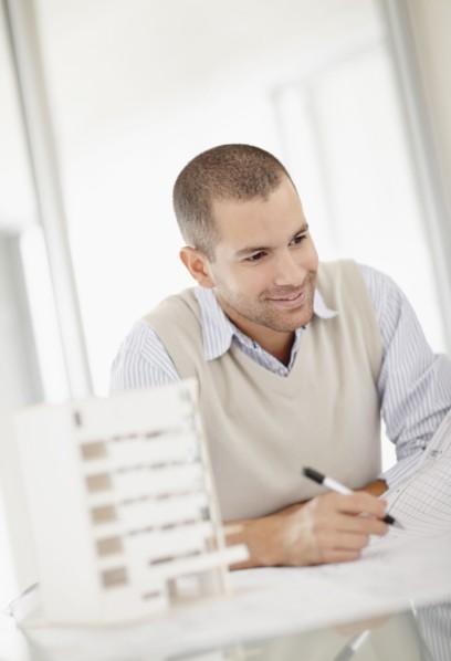 South Africa, Smiling architect working in office. Photo : momentimages
