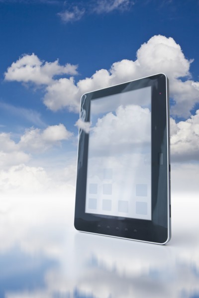 Digital tablet floating in clouds.