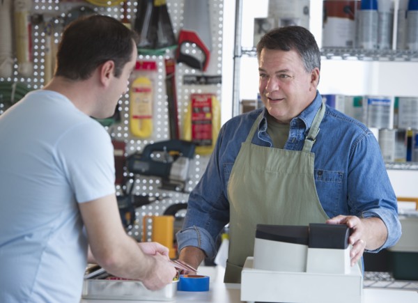 USA, New Jersey, Jersey City, Shop owner serving customer in hardware shop.