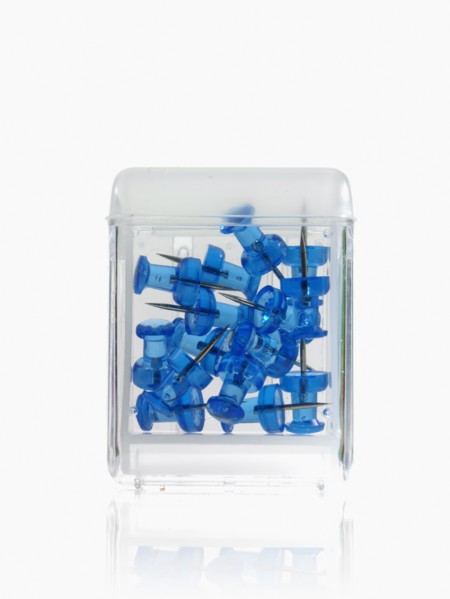 Studio shot of blue thumbtacks in glass cube. Photo : David Arky