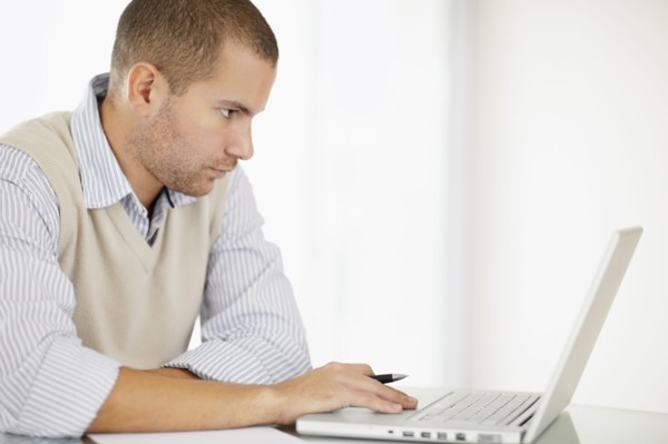 South Africa, Portrait of young man with laptop. Photo : momentimages