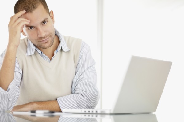 South Africa, Portrait of young man with laptop. Photo : momentimages
