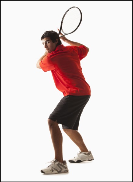 Young man playing tennis. Photo : Mike Kemp