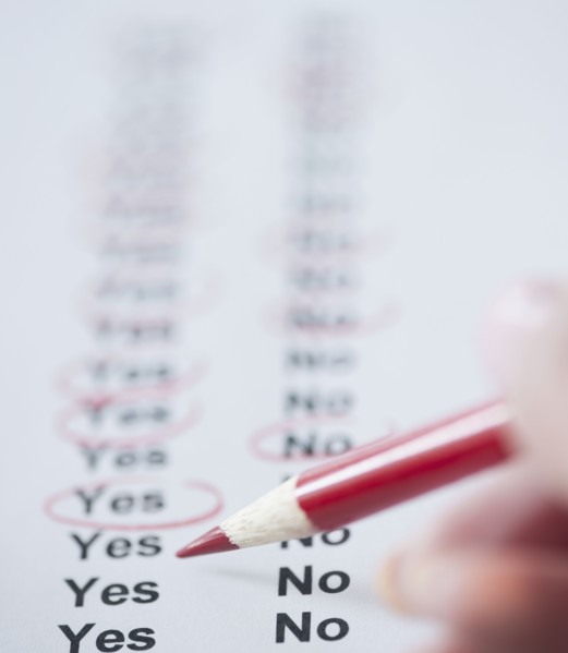 USA, New Jersey, Jersey City, Close-up view of woman's hand filling in form. Photo : Jamie Grill