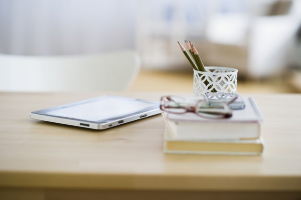 USA, New Jersey, Jersey City, Digital tablet and stationery on desk.