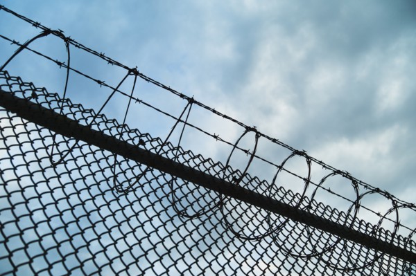 USA, New York, New York City, Barbed wire fence.