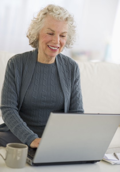 USA, New Jersey, Jersey City, Senior woman using laptop at home.