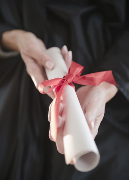USA, New Jersey, Jersey City, Close-up view of woman hands holding diploma. Photo : Jamie Grill