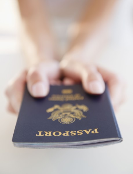 USA, New Jersey, Jersey City, Close-up view of woman's hands holding US passport. Photo : Jamie