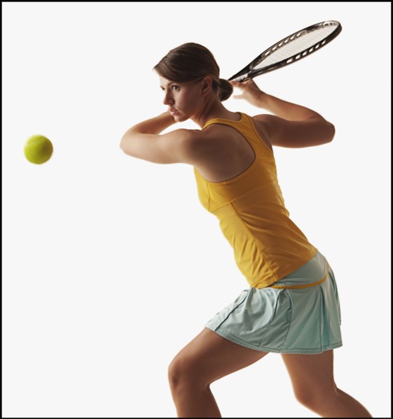 Young woman playing tennis. Photo : Mike Kemp