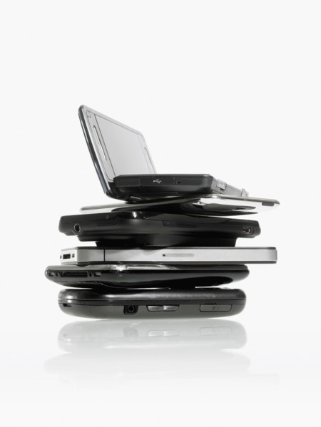 Studio shot of pile of laptops and palmtops. Photo : David Arky