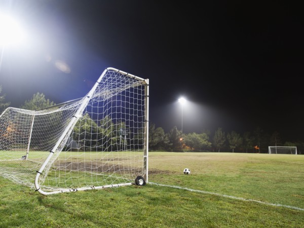 USA, California, Ladera Ranch, illuminated soccer field at night.