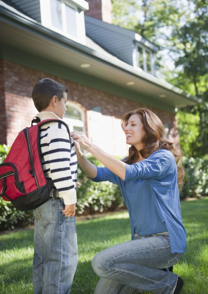 USA, New York, Flanders, Mother assisting boy (8-9) before departure to school. Photo : Jamie Grill