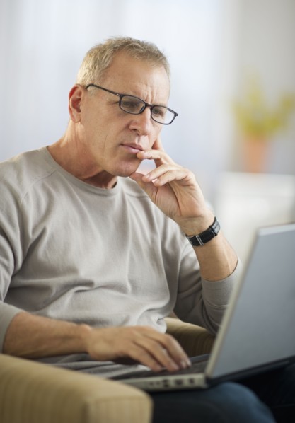 Mature man working on laptop.