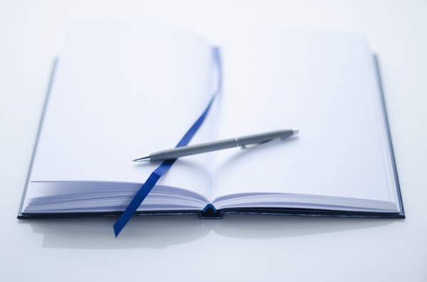 Empty personal organizer and pen.
