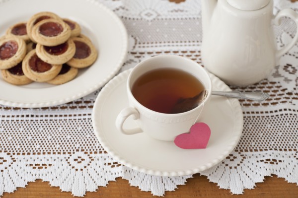 Heart shaped biscuit with cup of tea.
