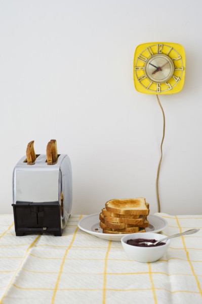 Toast in toaster on breakfast table.
