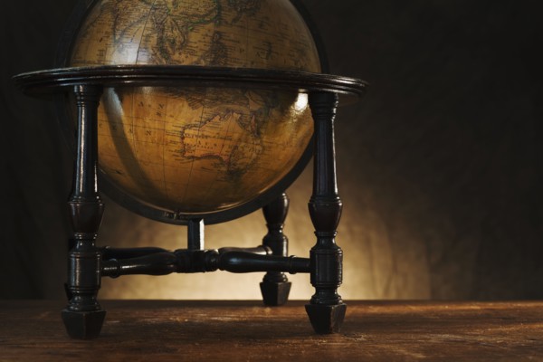 Close up of antique globe on table.